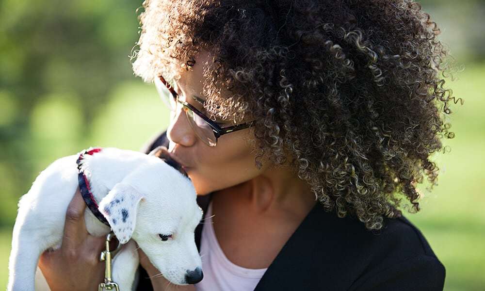 Woman Kissing Dog